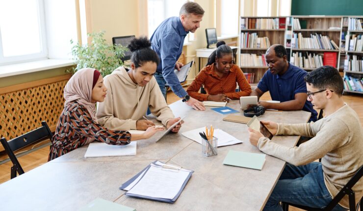Mature,Caucasian,English,Language,Teacher,Helping,Immigrant,Students,With,Doing
